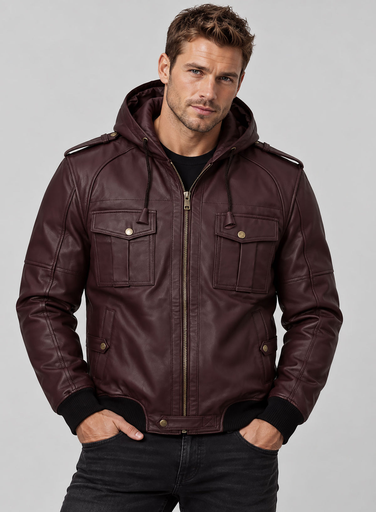 Close-up of man in a burgundy hooded leather jacket with brass zipper, flap pockets and ribbed cuffs