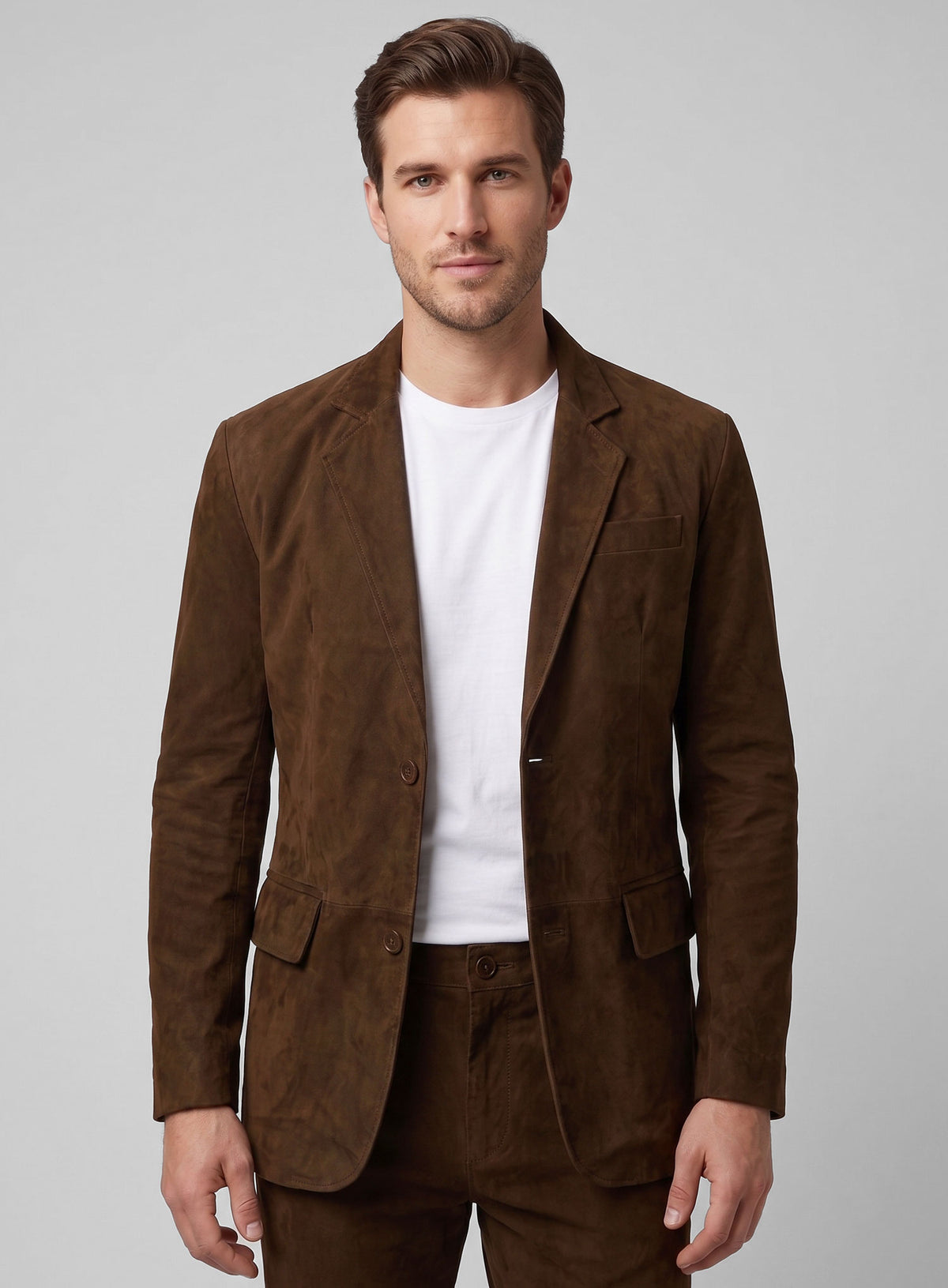 Man wearing a mid brown suede leather blazer with notch lapel and flap pockets