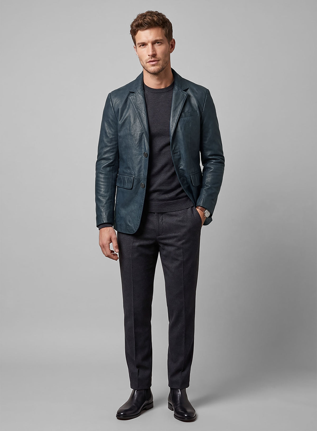 Full-length view of man in a blue lambskin leather blazer with dark trousers