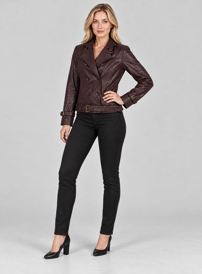 Full-length view of a woman in a burgundy double-breasted leather jacket with belted hem