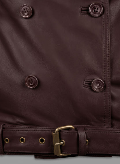 Close-up of burgundy leather jacket buttons and belt with brass buckle and eyelets