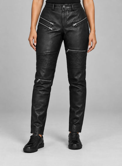 Woman wearing black leather biker pants with zip pockets and ribbed knee panels, front view