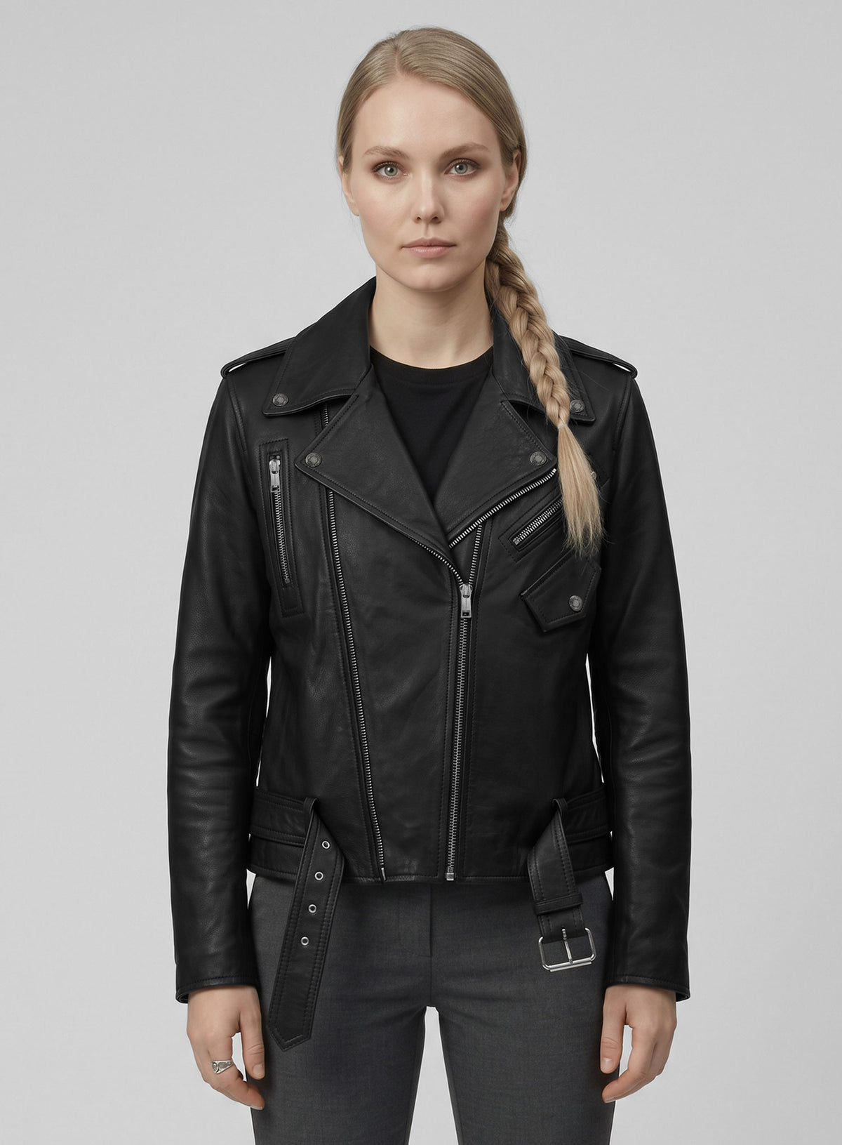 Woman wearing a black leather biker jacket with belted hem, asymmetric zip and epaulettes, front view