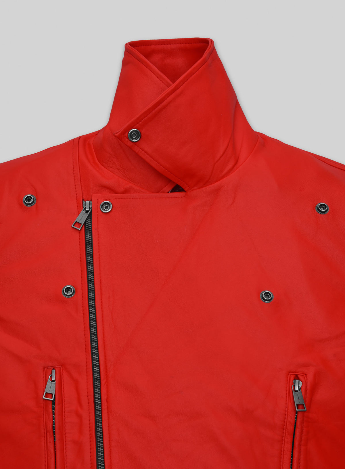 Close-up of red leather biker jacket collar with snap tab and asymmetric zip