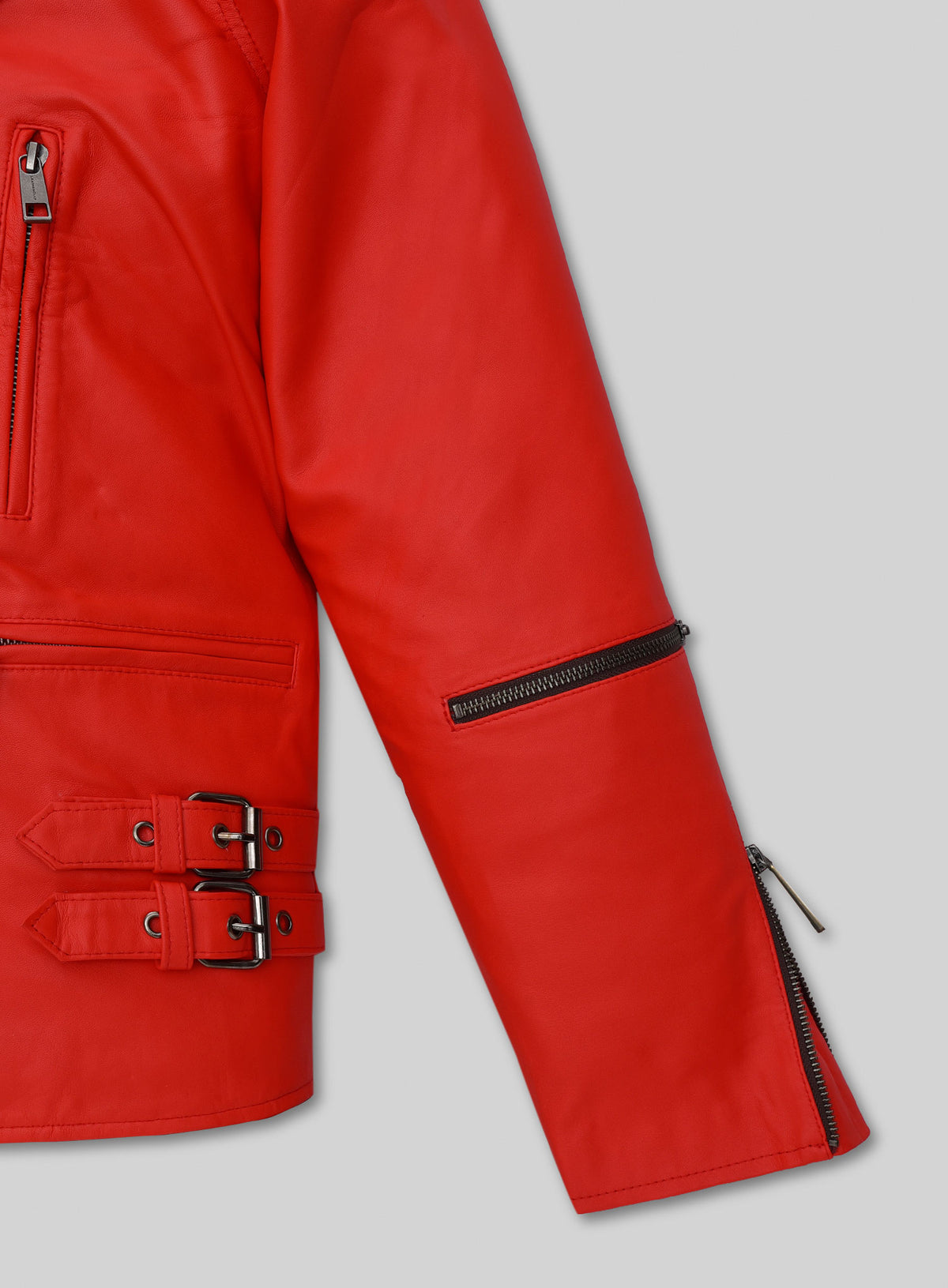 Detail of red leather biker jacket sleeve zip, side buckle straps and zip pocket