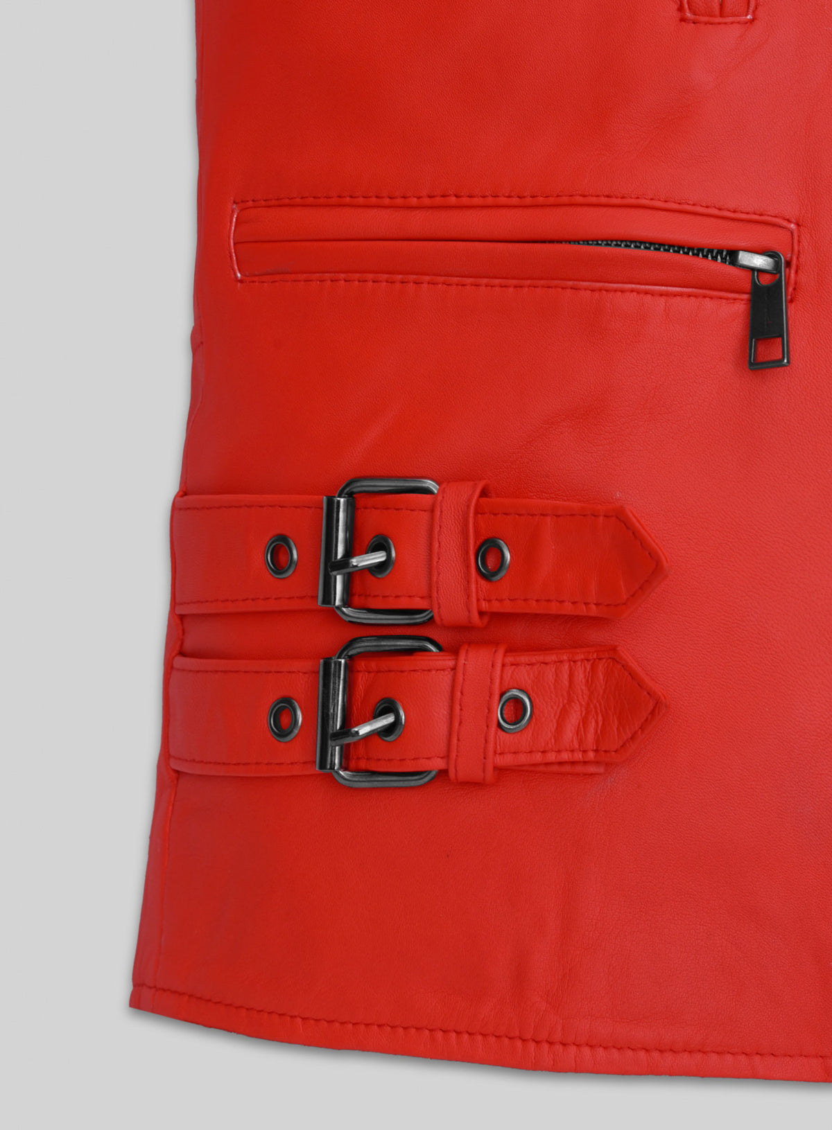 Close-up of red leather jacket double buckle straps and zip pocket