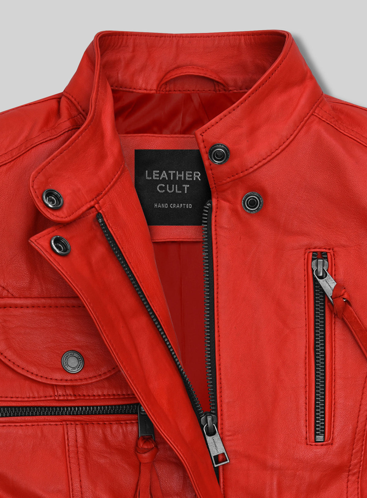 Close-up of red leather jacket stand collar, snap buttons, zipper and pockets
