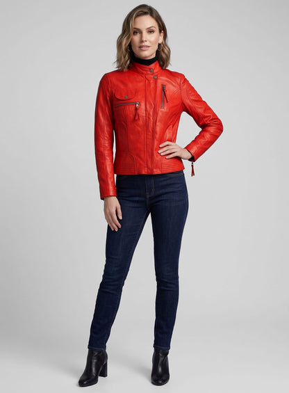 Woman wearing a red washed lambskin leather jacket with stand collar and zip pockets, with jeans and black boots
