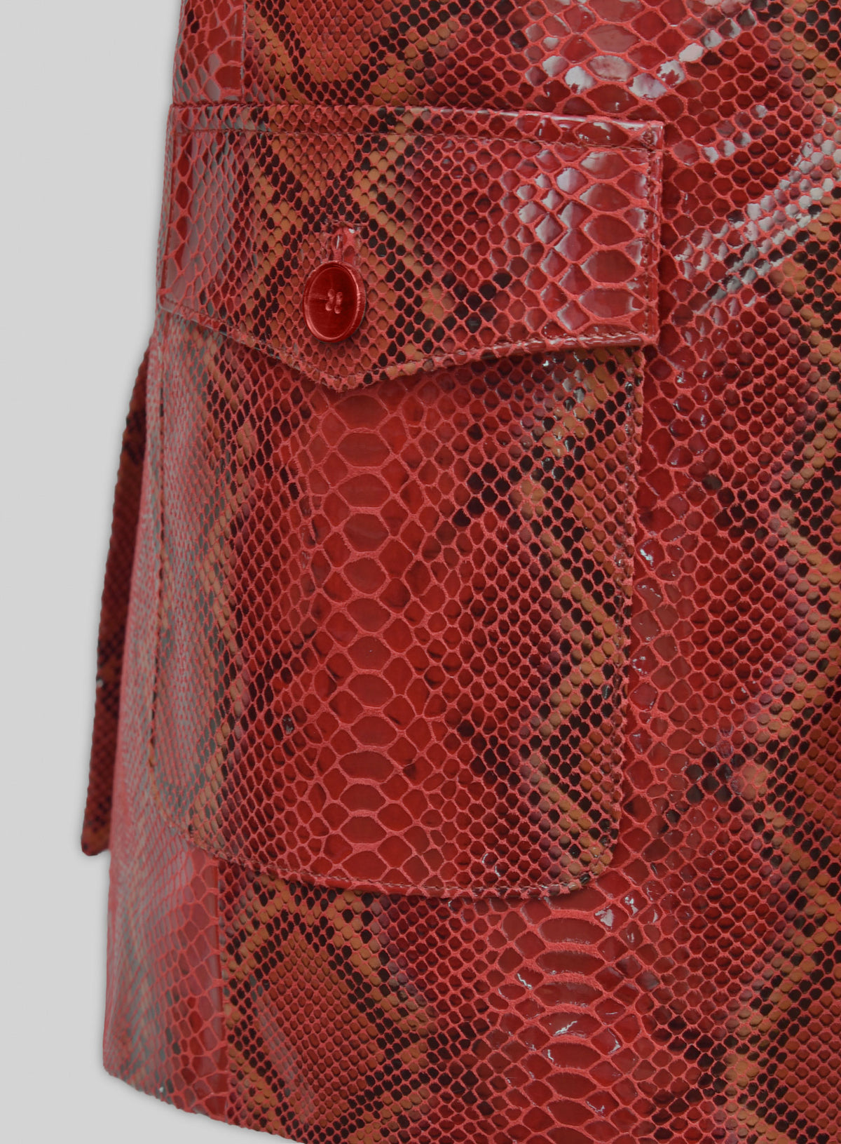 Close-up of flap pocket on a red python-print western leather blazer