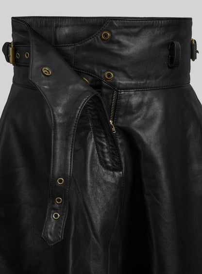 Detail of black leather flare skirt with open waistband, snaps, zipper and eyelet strap