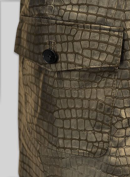Close-up of antique gold croc leather blazer flap pocket with black button