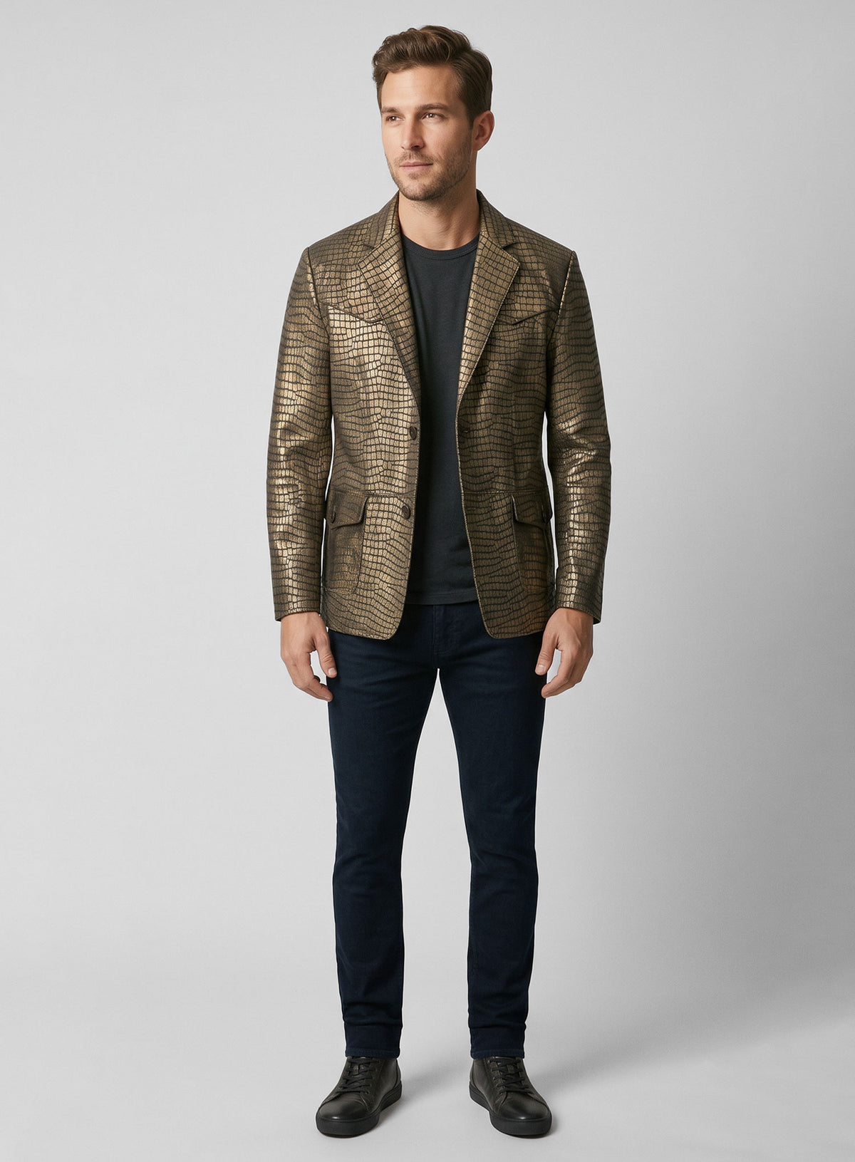 Man wearing an antique gold croc leather western blazer with dark jeans, full length view