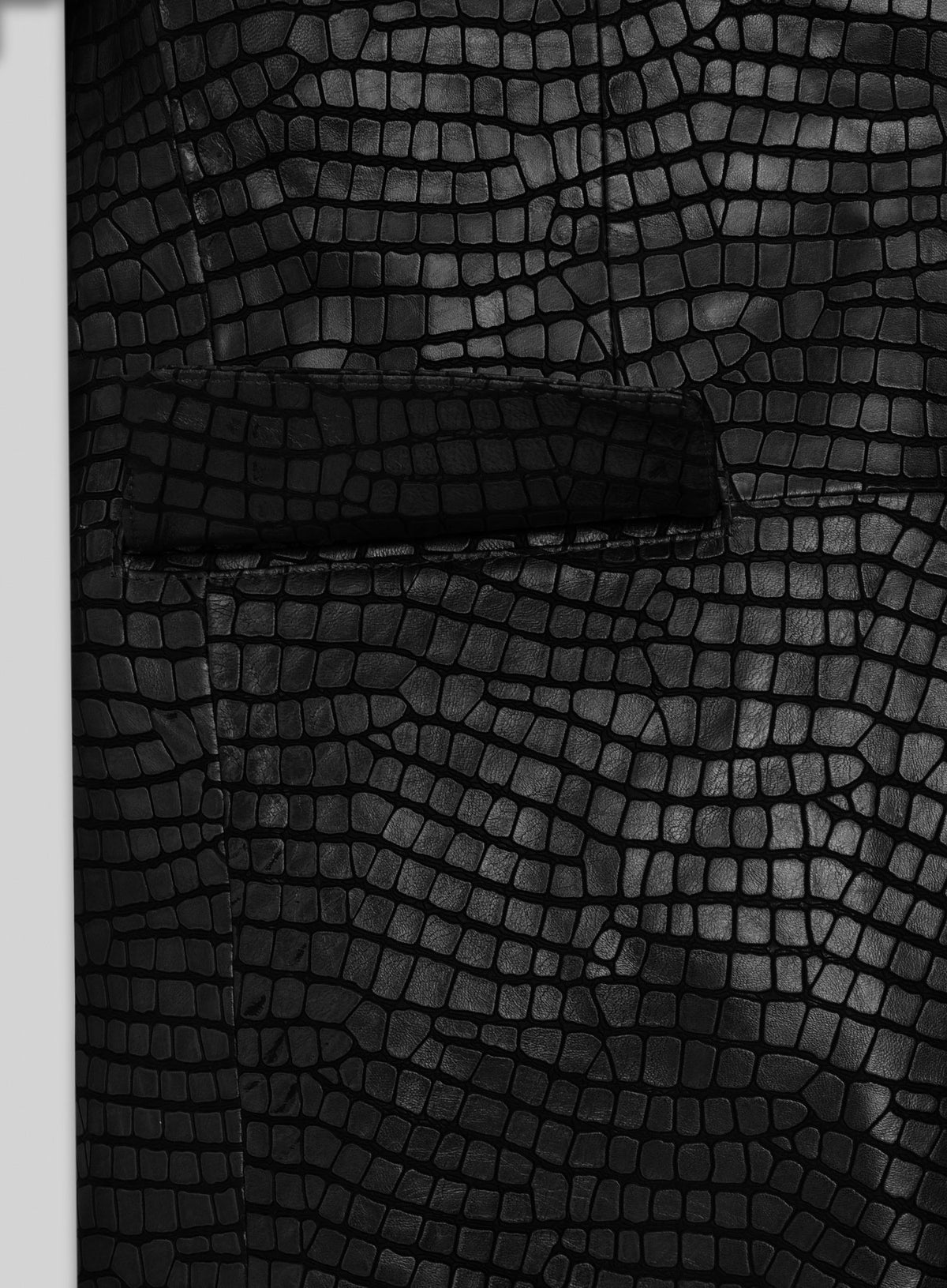 Close-up of black croc-embossed leather blazer flap pocket