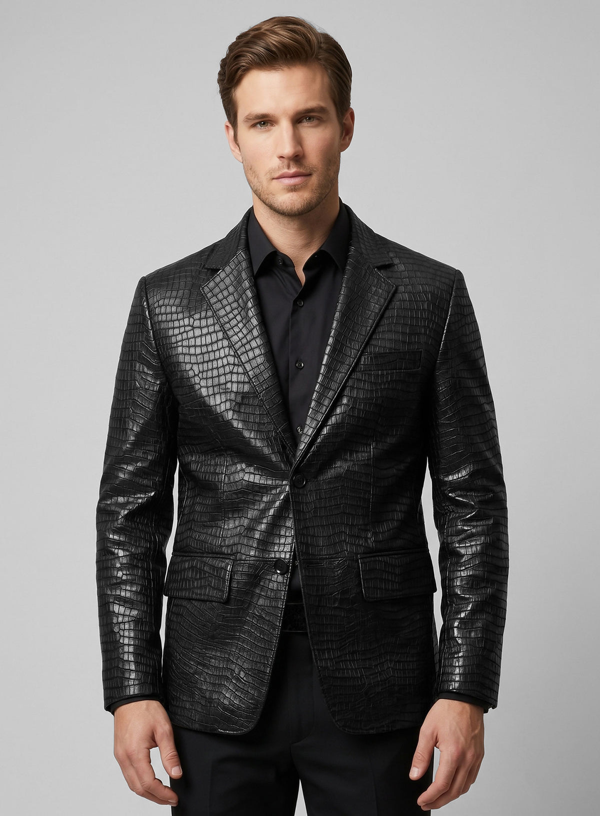 Man wearing a black croc-embossed leather blazer with notch lapel over a black shirt