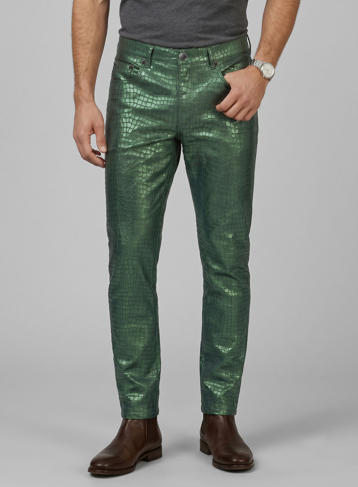 Man wearing metallic green croc-embossed leather jeans-style pants, front close-up