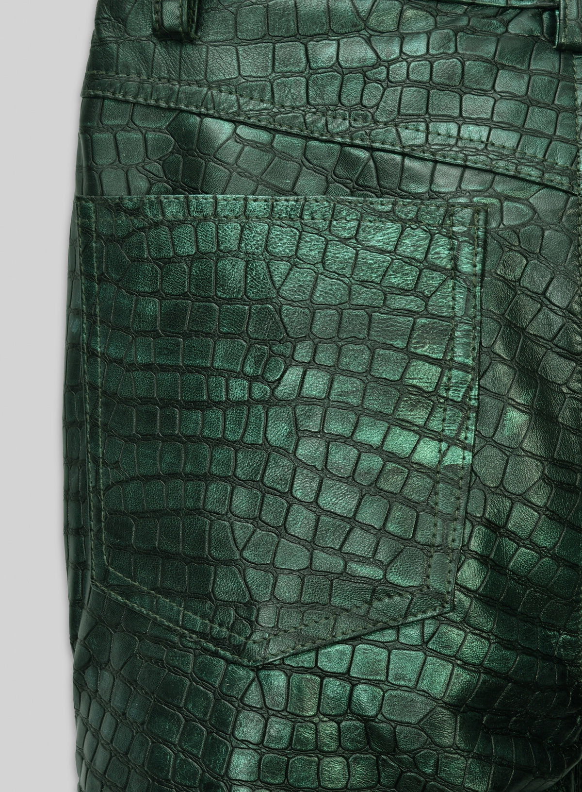 Close-up of back pocket on metallic green croc-embossed leather jeans-style pants