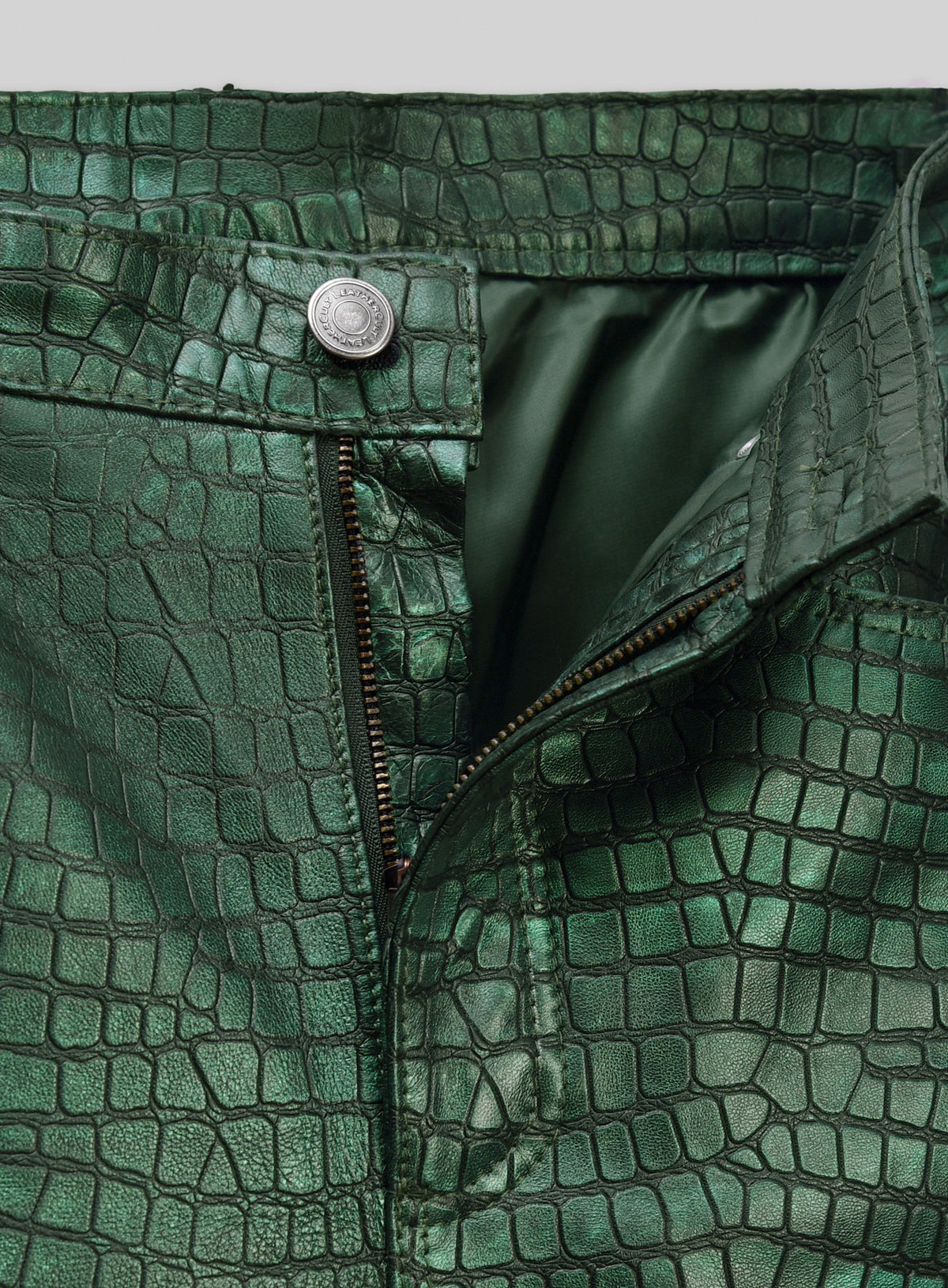 Waistband with button and zip fly of metallic green croc leather pants, green lining visible