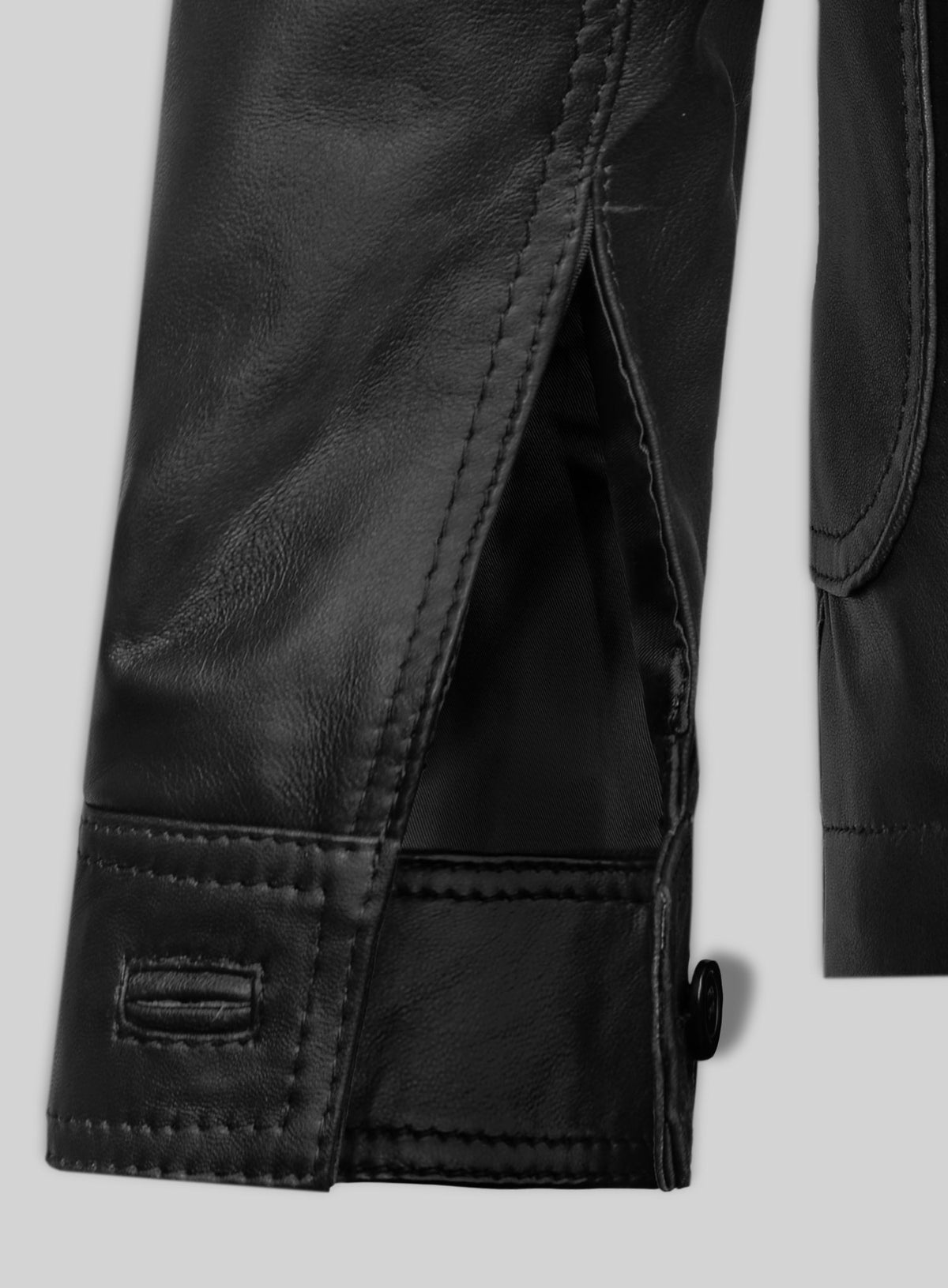 Close-up of sleeve cuff with vent and button on a black leather blazer