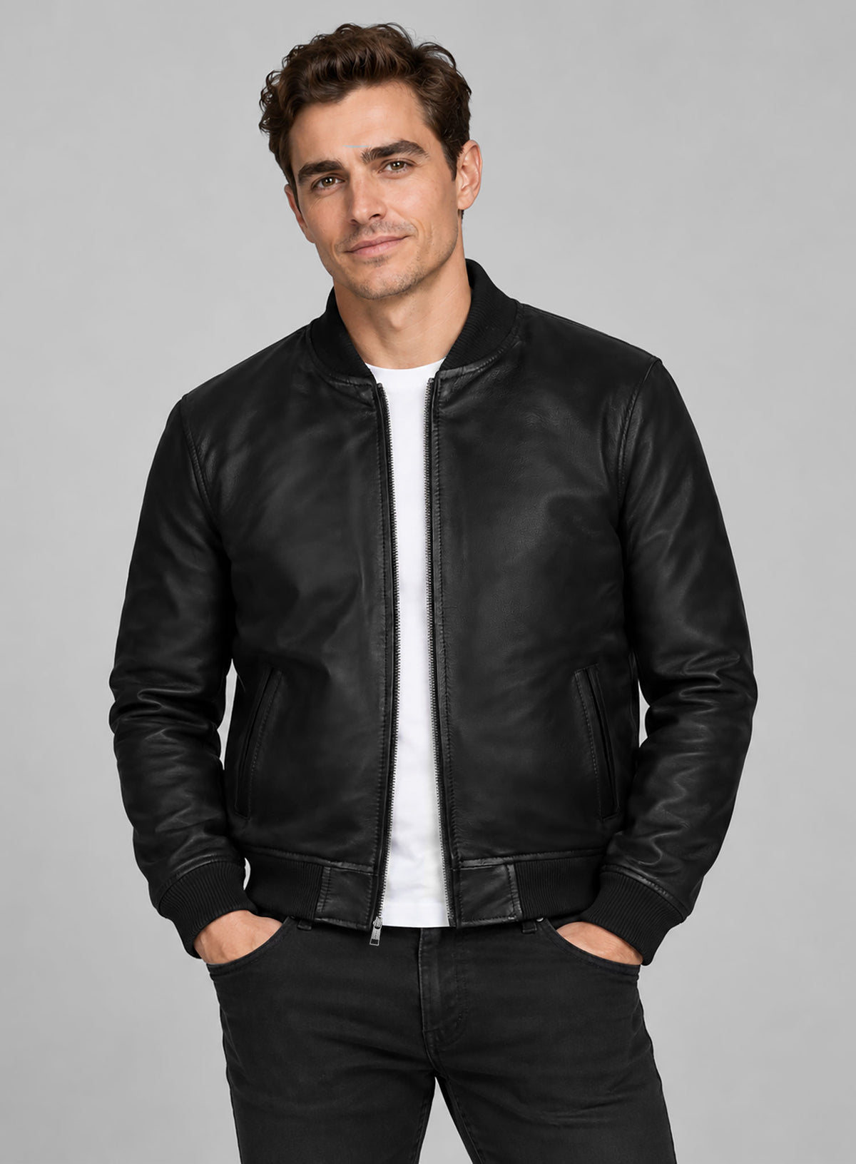 Man wearing a black leather bomber jacket with ribbed collar and cuffs, front view