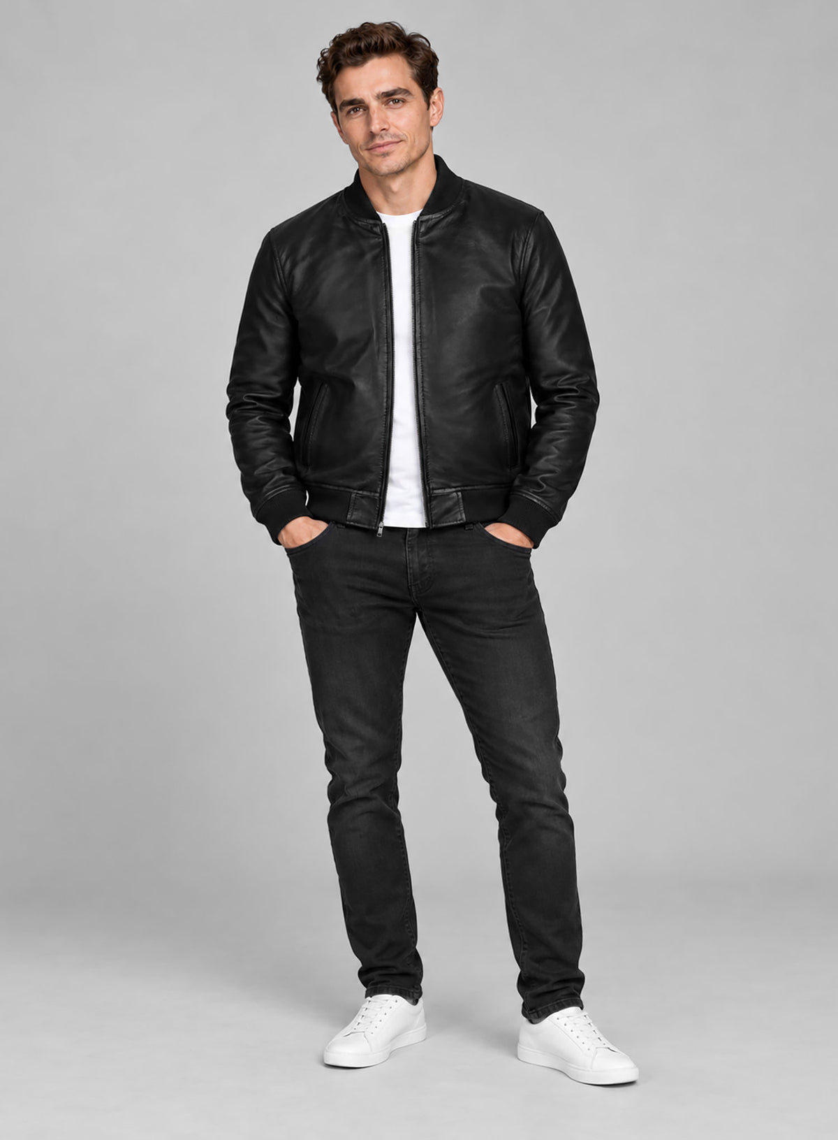 Full-length view of a man wearing a black leather bomber jacket with black jeans