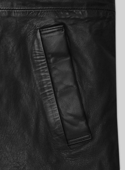 Close-up of black leather long coat flap pocket