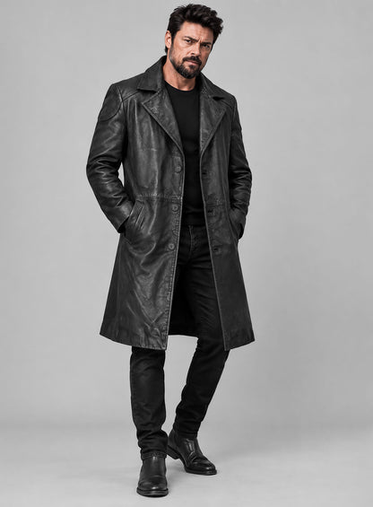 Full-length view of a man wearing a black leather long coat with black jeans and boots