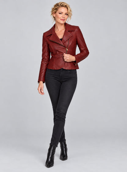 Full-length view of a woman wearing a red leather biker jacket with asymmetric zip and black jeans