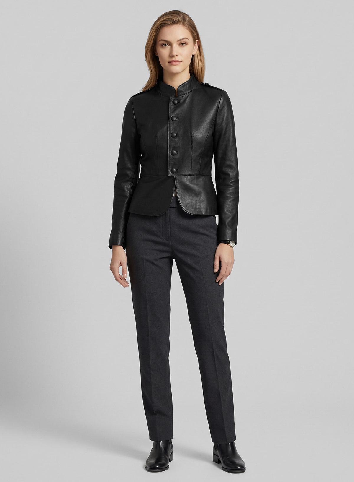 Full-length view of a woman wearing a black leather peplum jacket with grey trousers