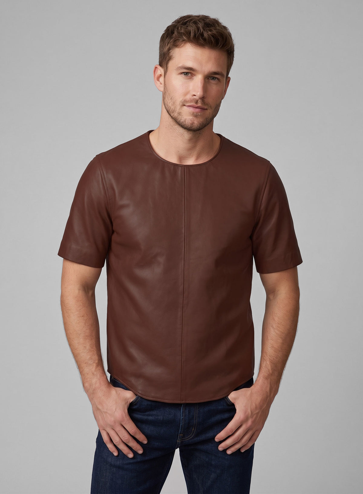 Man wearing a brown leather t-shirt with crew neck and jeans