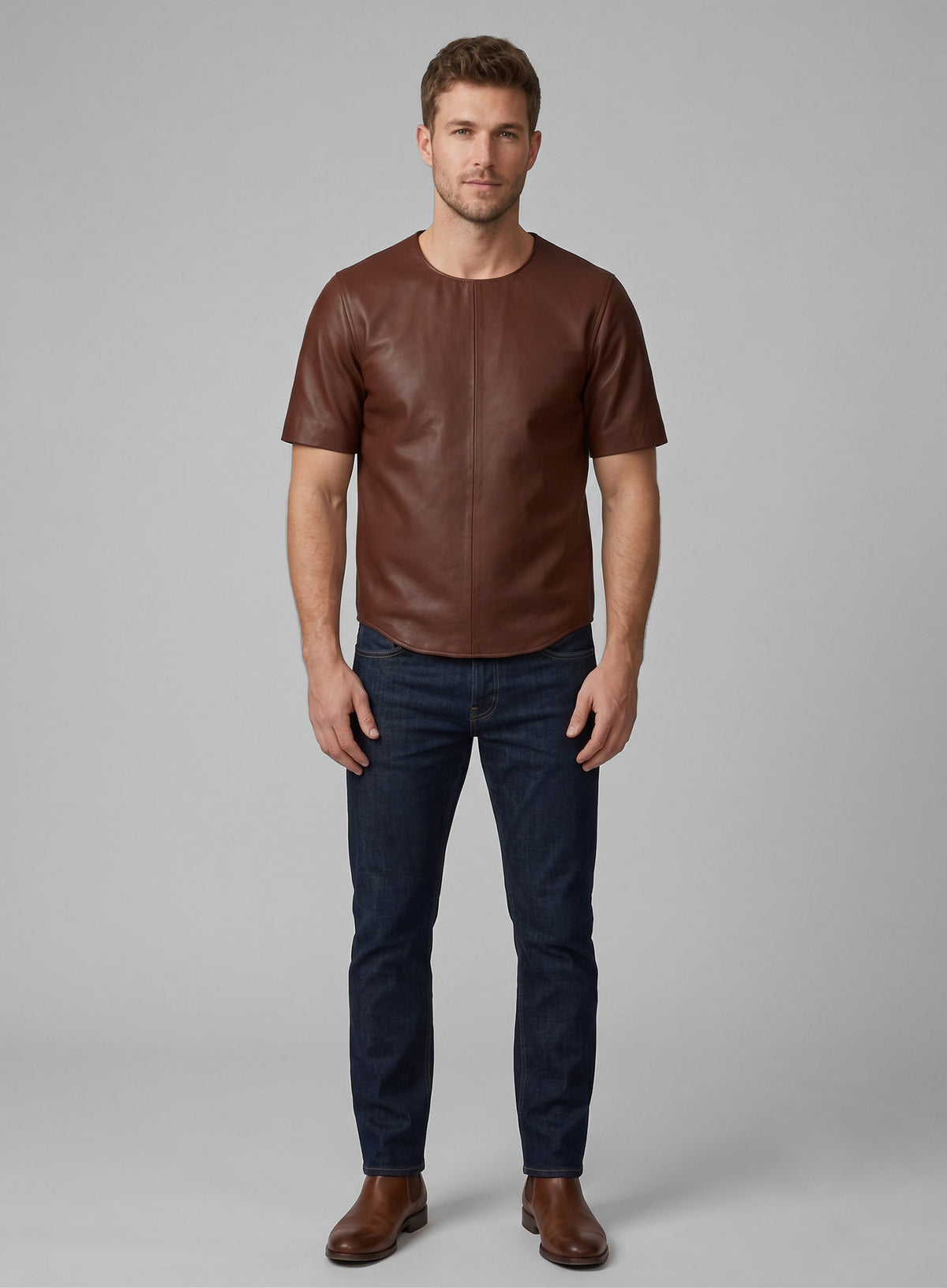 Full-length view of man in brown leather t-shirt and dark jeans
