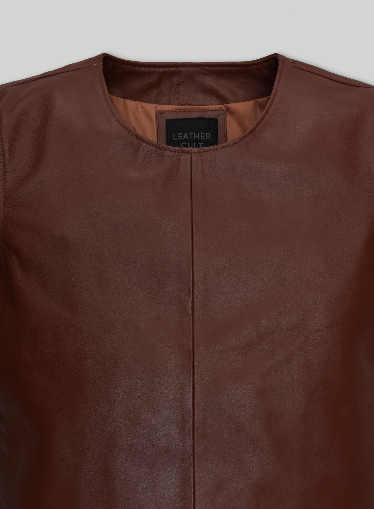 Close-up of brown leather t-shirt crew neckline and label
