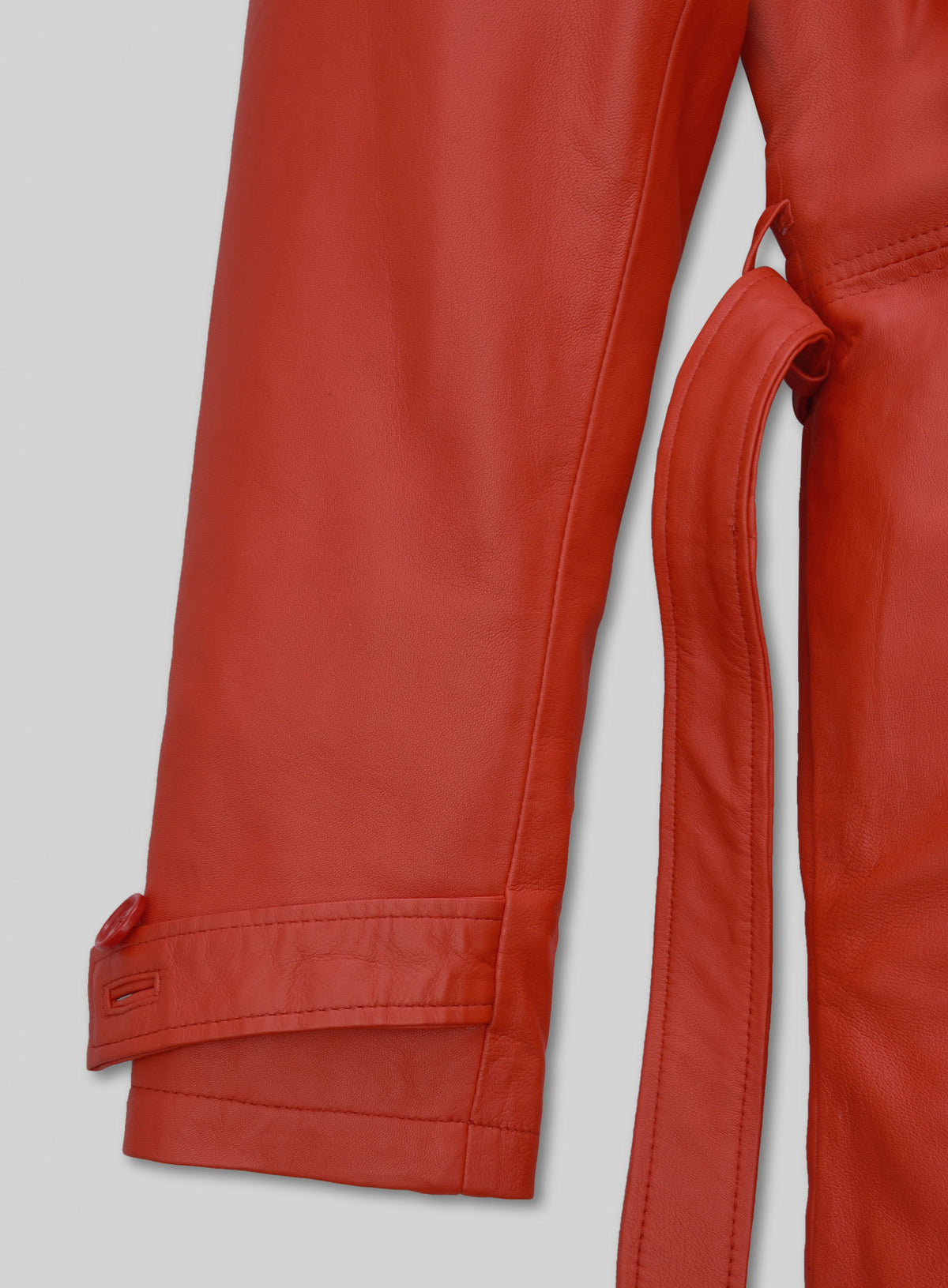 Red leather long coat sleeve with buttoned cuff strap and belt detail