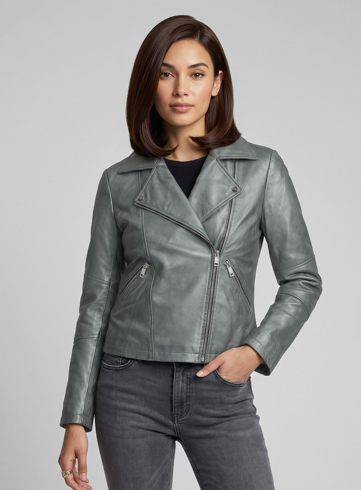 Woman wearing a metallic grey leather biker jacket with asymmetric zip and notch lapel, three-quarter view