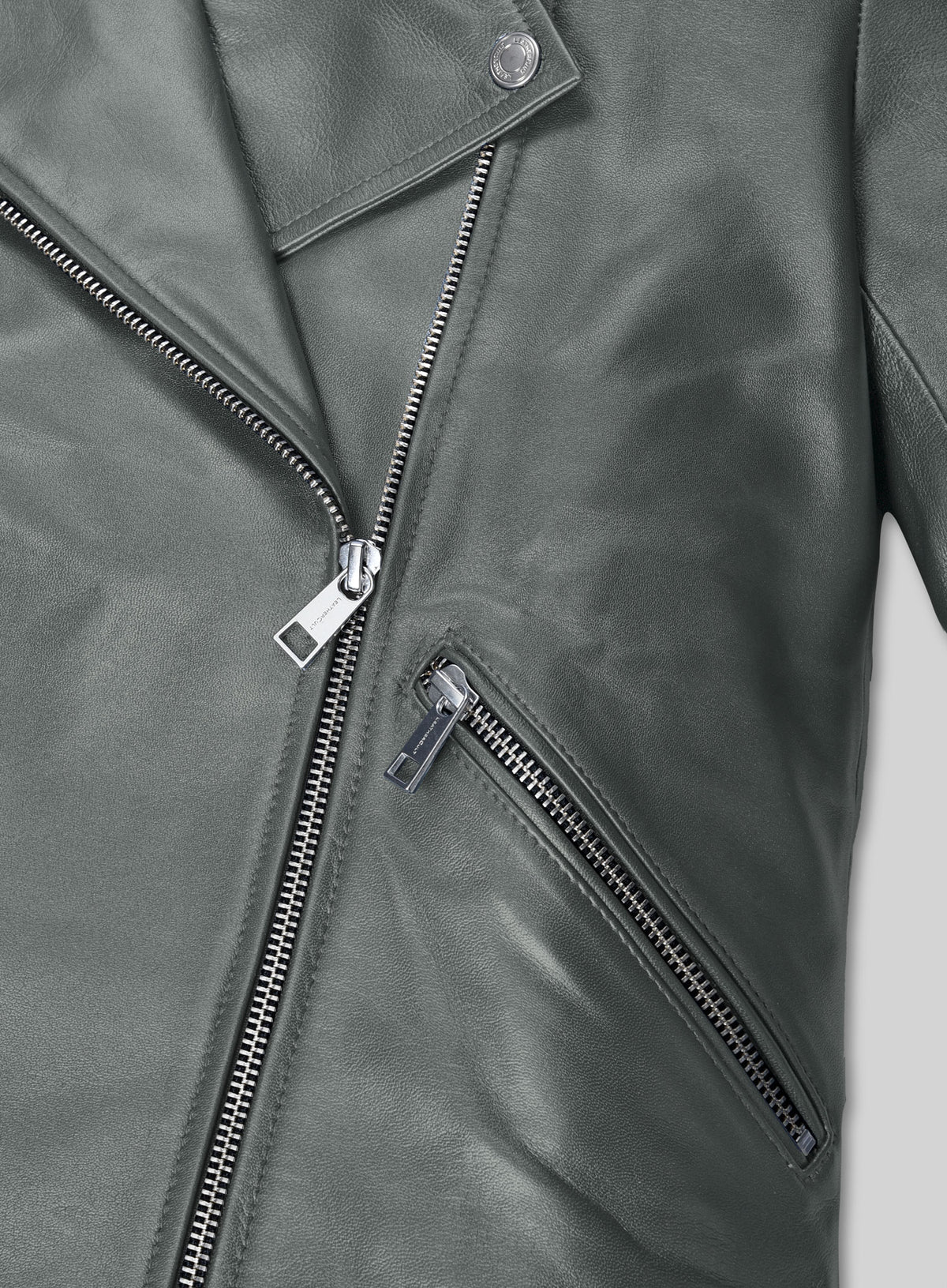 Close-up of a metallic grey leather biker jacket with asymmetric zipper, collar snap and zip pocket
