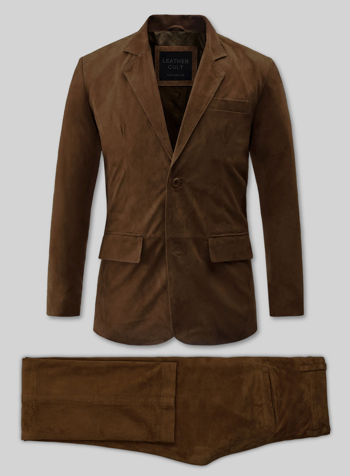Flat lay of a mid brown suede leather suit with two-button blazer and trousers