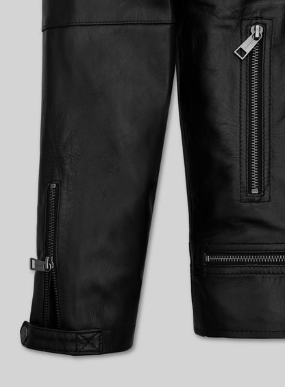 Detail of black leather jacket sleeve with zip cuff, zip pocket and snap tab