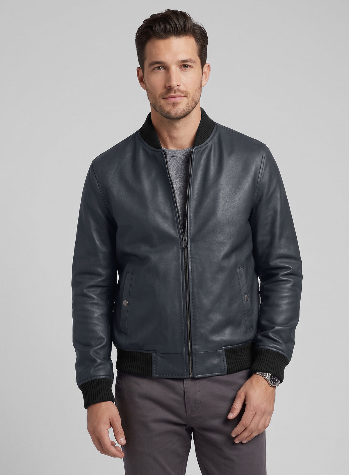 Man wearing a grey-blue lambskin leather bomber jacket with zip front and ribbed trim