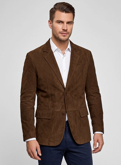 Three-quarter view of a man wearing a mid brown suede leather blazer with notch lapel and flap pockets