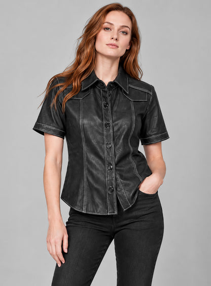 Woman wearing a black short-sleeve leather shirt with white contrast stitching