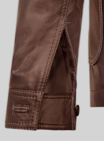 Close-up of tan brown leather blazer cuff with button and sleeve vent