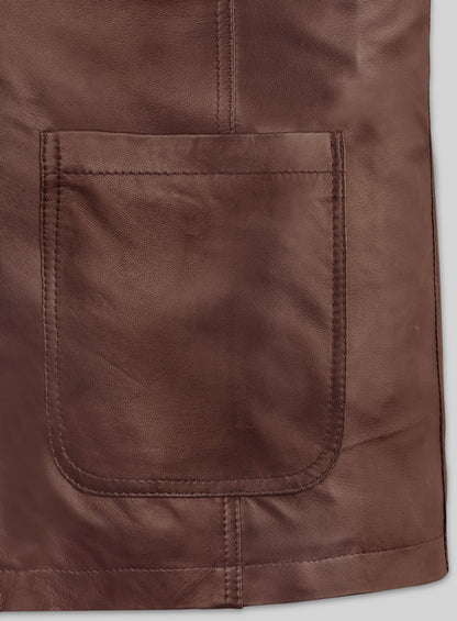 Close-up of patch pocket and hem stitching on a tan brown leather blazer