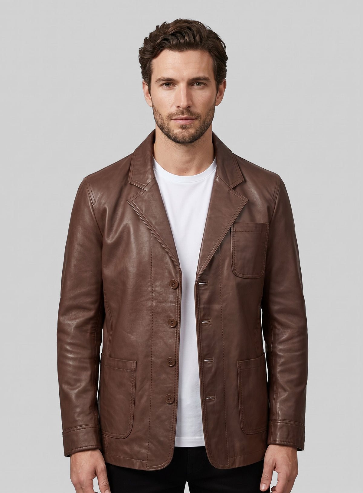 Man wearing a tan brown leather blazer with white t-shirt, front view