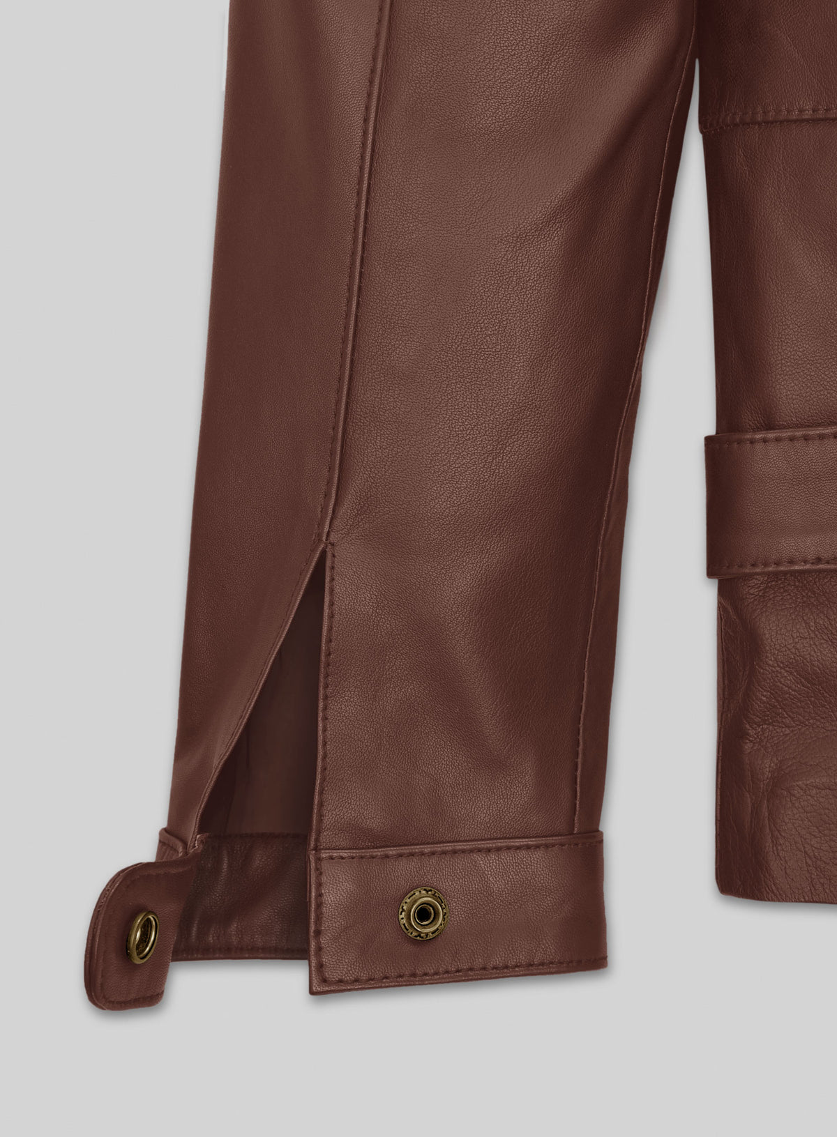 Close-up of brown leather jacket cuff with snap button and sleeve vent
