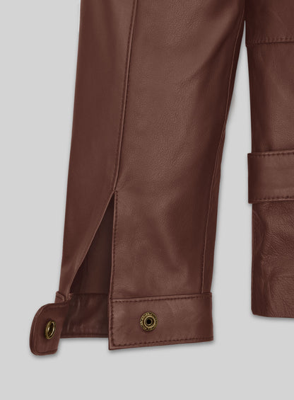 Close-up of brown leather jacket cuff with snap button and sleeve vent