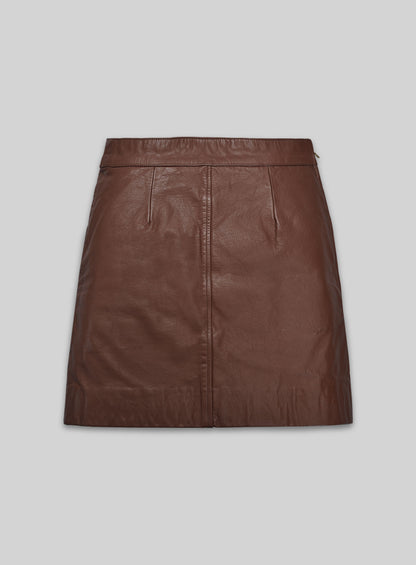 Back view of a tan brown washed wax leather mini skirt with darts and centre seam