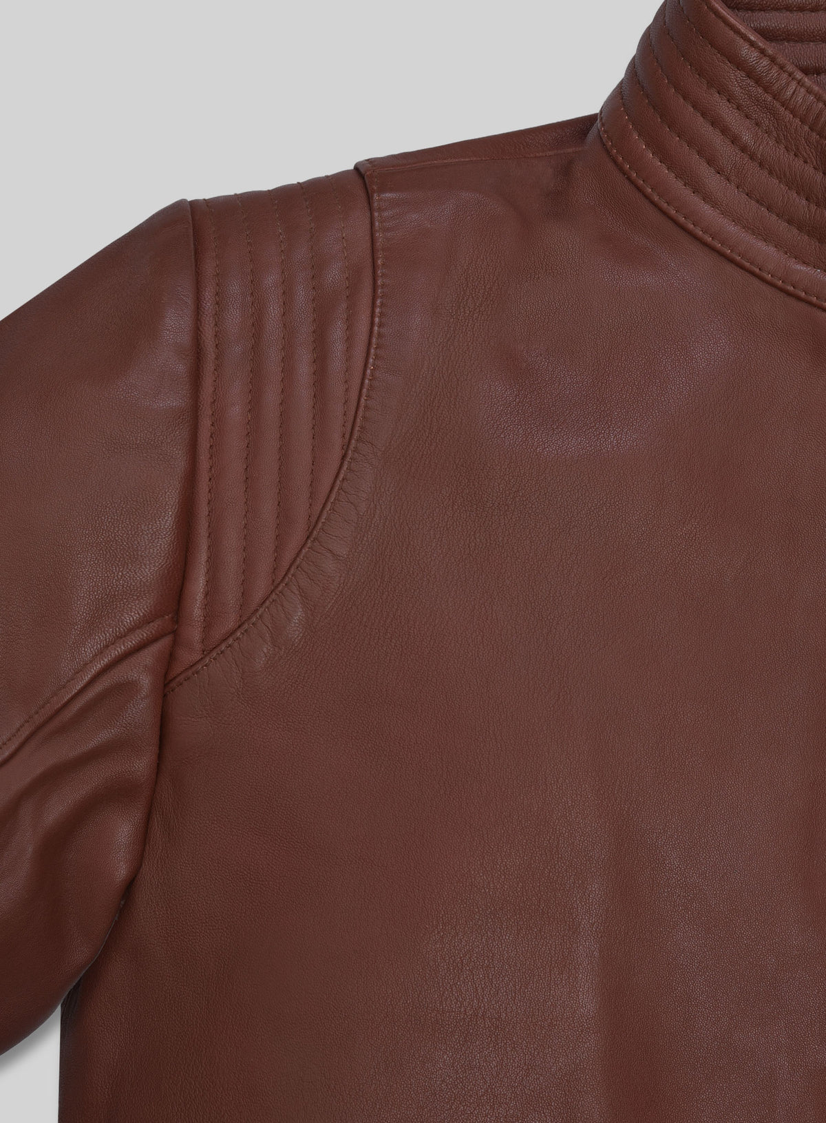 Close-up of quilted shoulder and stand collar of tan brown washed wax leather jacket