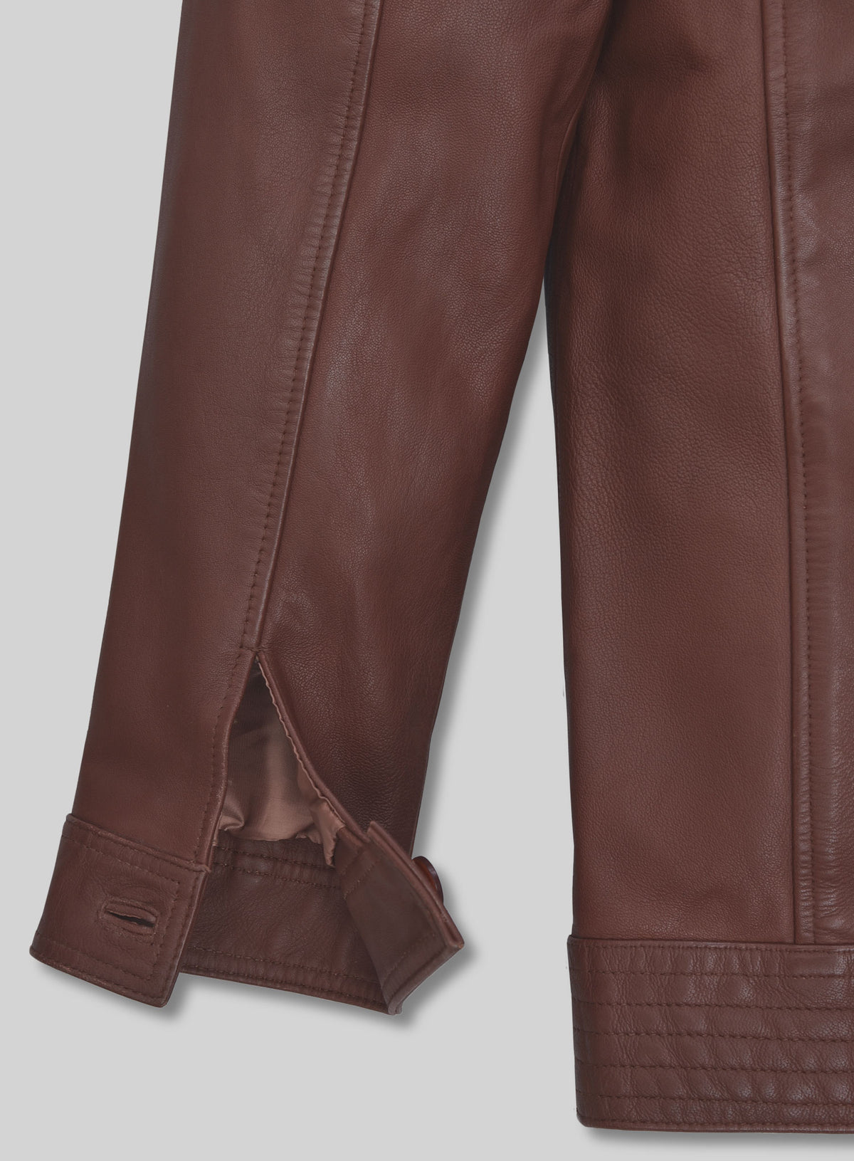 Close-up of button cuff and sleeve vent on tan brown washed wax leather jacket