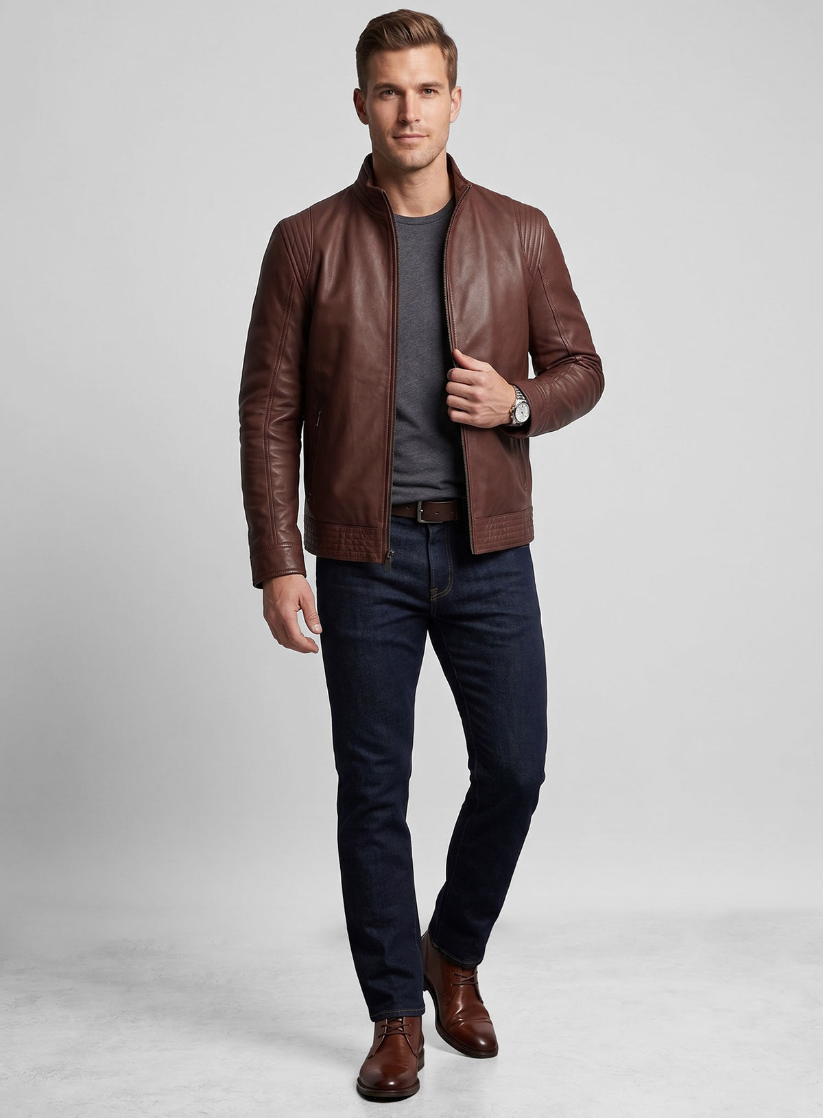 Full-length view of man in a tan brown washed wax leather jacket with jeans and boots