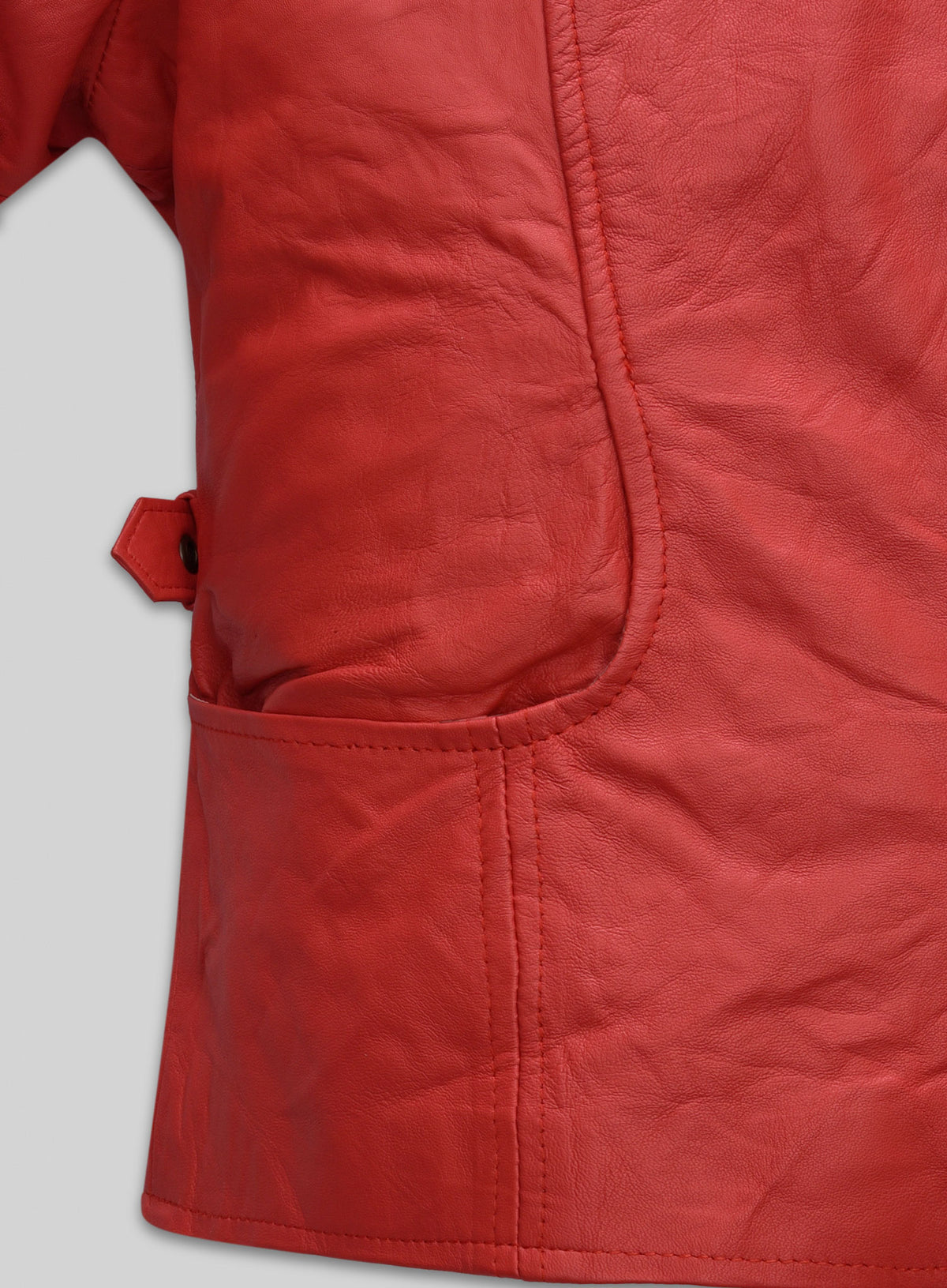Close-up of the pocket and side tab on a red washed lambskin leather jacket