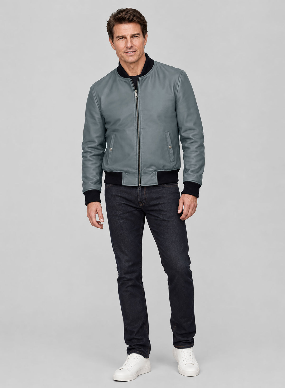 Full-length view of a man wearing a grey leather bomber jacket with dark jeans